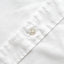 A closeup of the placket and mother of pearl button.