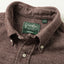 A closeup of the button down collar of the brown herringbone flannel with a green Gitman brothers vintage tag.
