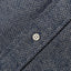 The placket of the navy herringbone flannel with a white button.
