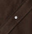 A dark brown corduroy fabric placket, with a white pearl button.