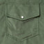A sage corduroy front pocket with a white pearl button.