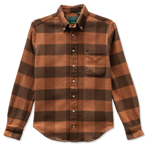 A orange brushed waffle checkered button down with a chest pocket and made from heavyweight Japanese woven knit and made in the USA.