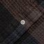 A closeup look of the black waffle placket with a white button.
