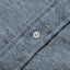 Close-up of the Blue Nepped Chambray sport shirt's button placket featuring classic buttons and textured nepped chambray fabric.