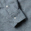 Close-up of the Blue Nepped Chambray sport shirt's lined cuff and buttons, showcasing its textured nepped chambray fabric.