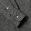Close-up of the Charcoal Nepped Chambray sport shirt's lined cuff and buttons, showcasing its textured nepped chambray fabric.