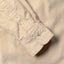 Close-up of the Tan 16-Wale Corduroy sport shirt's lined cuff and buttons, showcasing its fine-wale cotton corduroy fabric.