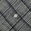 Close-up of the Prince of Wales Tweed sport shirt's button placket featuring classic buttons and textured checked tweed fabric.