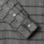Close-up of the Prince of Wales Tweed sport shirt's lined cuff and buttons, showcasing its textured woven tweed fabric.