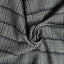 Close-up of the Prince of Wales Tweed sport shirt's textured tweed fabric, showcasing its distinctive Prince of Wales check pattern and woven texture.