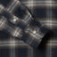 Close-up of the Navy Checked Tweed sport shirt's lined cuff and buttons, showcasing its textured woven tweed fabric.