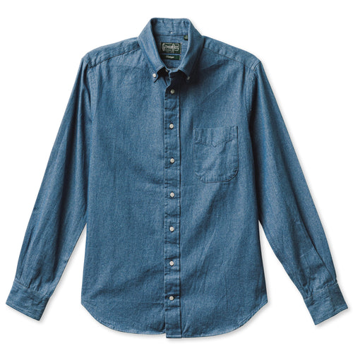 A light denim shirt with a pocket and white buttons, includes barrel cuffs and made from 100% cotton made in the USA.
