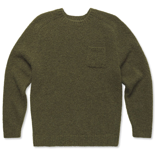 The olive alpaca sweater, with triple brushed fabric and ribbed cuffs an collar and a front pocket.